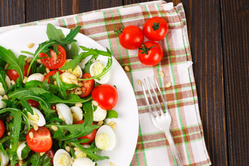 Salad with arugula on a wooden background