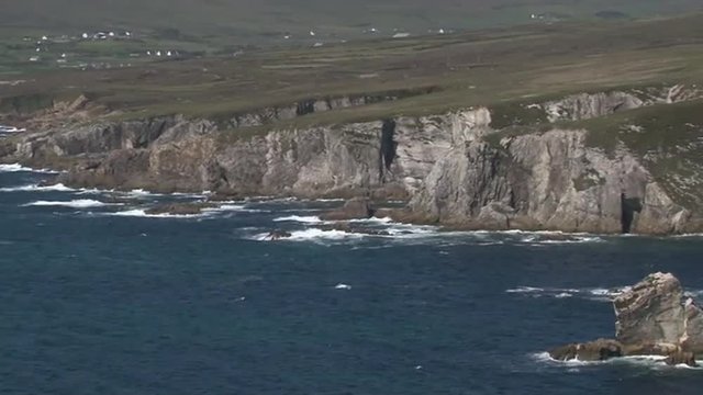 View on a rocky coastline with waves breaking on rocks.