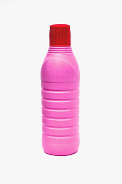 Pink plastic bottles on white background