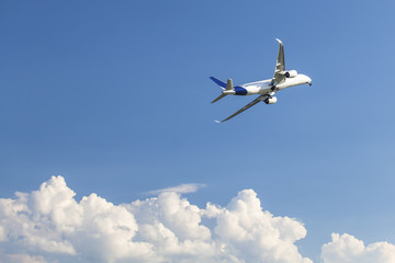 Fototapeta na wymiar Jumbo jet airplane flying above the clouds.