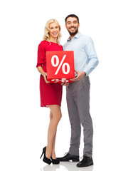 happy couple with red sale sign