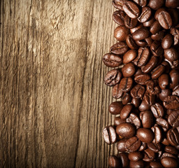 Coffee beans on grunge wooden background