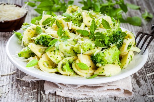 homemade pasta orecchiette with broccoli, Parmesan cheese and basil