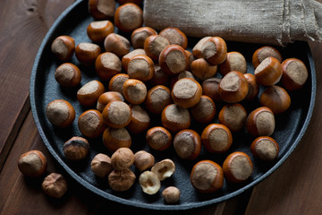 Close-up of hazelnuts in a frying pan, studio shot