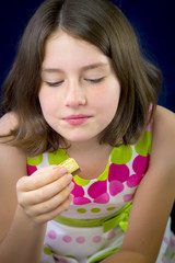 Beautiful teenage girl eating chocolate