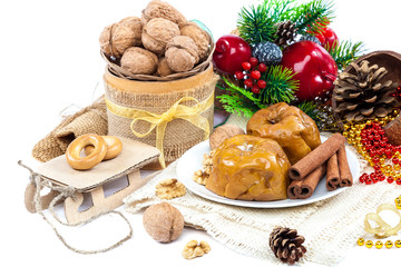 Baked apples with nuts and cinnamon with Christmas decorations.