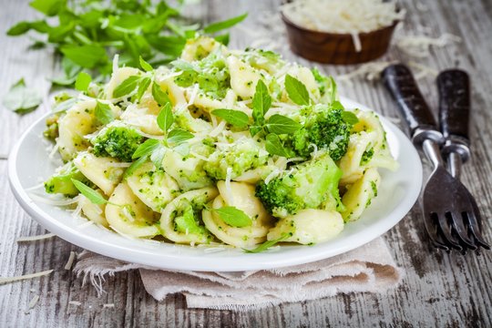 homemade pasta orecchiette with broccoli, Parmesan cheese and basil