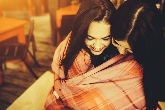 Two Young And Beautiful Girls Having Fun In Cafe