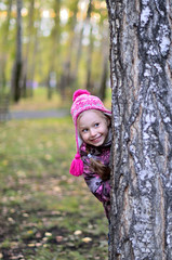 happy little child girl playing in the autumn park