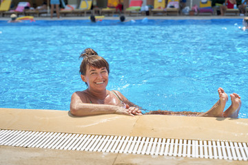 Woman relaxing on the swimming pool