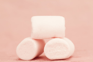 sweet marshmallows on a pink background