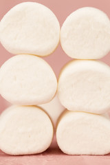 Fototapeta na wymiar sweet marshmallows on a pink background