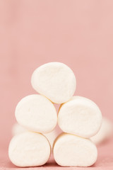 sweet marshmallows on a pink background