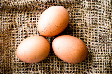 Fresh raw group of eggs put on old sack