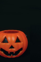 Plastic pumpkin black background