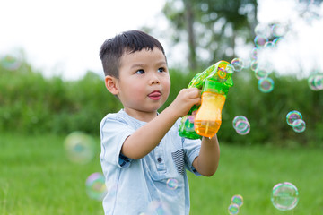 Cute boy play with bubble soap