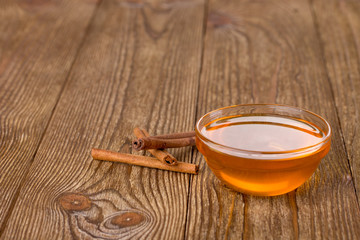 Honey and cinnamon on a wooden table