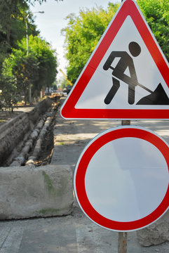 Road signs in street under reconstruction