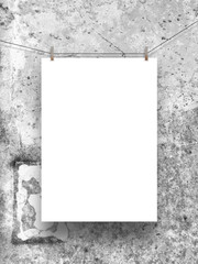 One hanged paper sheet with pegs on stained concrete wall background