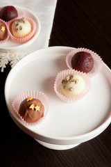 chocolate candies on white tray, close up vertical