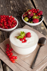 yogurt with berries and breakfast foods, vertical