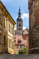 Bamberg. Street of the old town and the church bell tower of St. Stephen.  Historic city center of Bamberg is a listed UNESCO world heritage site