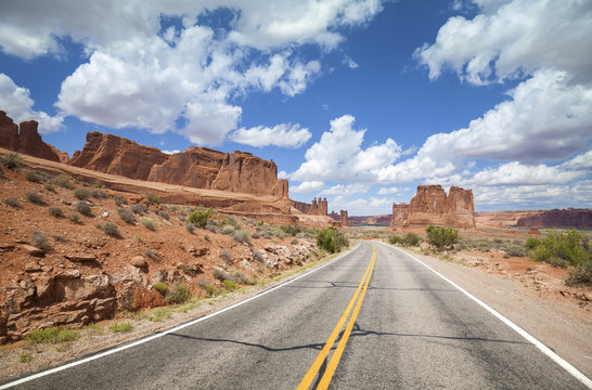 Scenic desert road with beautiful cloudscape, travel concept, Utah, USA.