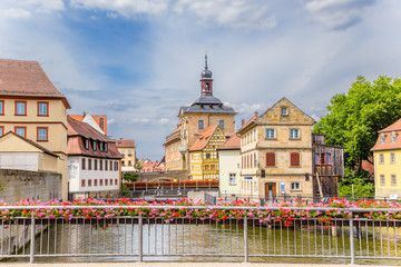 Naklejka premium Bamberg. Picturesque views of the old town hall (1461), bridges decorated with flowers and old buildings on the islands in the Regnitz river