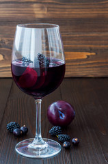Black sangria with plums and berries. Copy space background