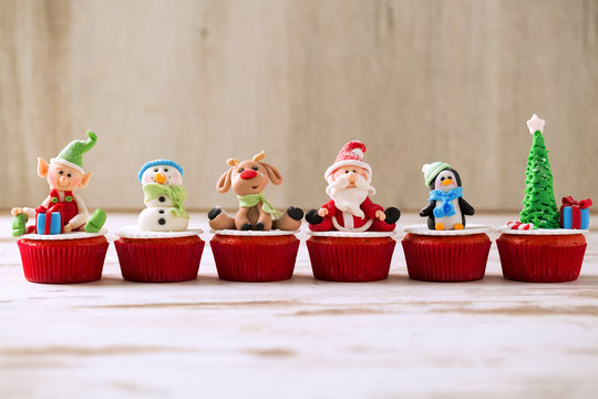 Group of christmas cupcakes on wooden background
