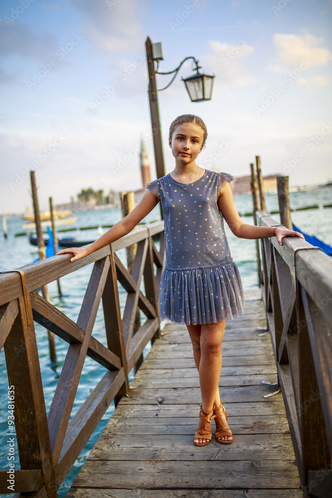 Wall mural portrait of young and beautiful girl in venice, italy. san giorgio maggiore church in background.