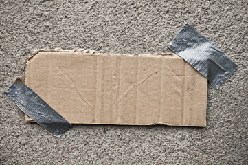 Photo of an cardboard piece taped with duct tape