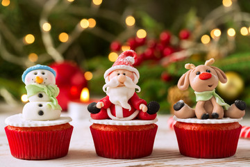 Three traditional decorated christmas cupcakes with festice back