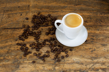 cup of coffee and beans on table