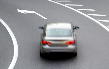 car on street with arrow direction
