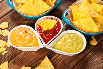 Plate of nachos with different dips