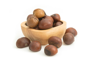 roasted chestnuts in wooden bowl on white background