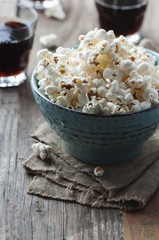 Popcorn and cola on the wooden table