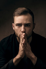 Shocked young man on dark background