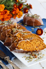 Pumpkinbread, topped with sugar icing and decorated with pumpkin seeds.selective focus