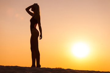 woman silhouette on sunset background