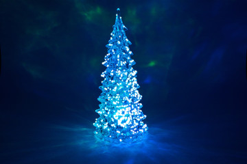 Christmas tree toy shining with a beautiful shadow Northern Lights background and highlights in the form of stars 
