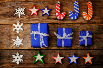 wooden background with wooden toys, gifts and the snowflakes