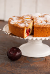 Pie with plums in powdered sugar.selective focus