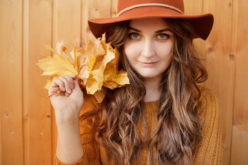 fashion style portrait of young trendy woman in fashionable hat