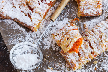 Sweet puff with pumpkin, sprinkled with powdered sugar.selective focus