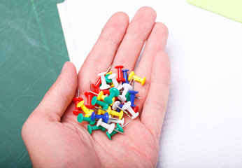 Colorful pins in hand