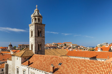 Fototapeta premium Dominican Monastery's bell tower and red roofs at the Old Town in Dubrovnik in Dubrovnik, Croatia. Copy space.