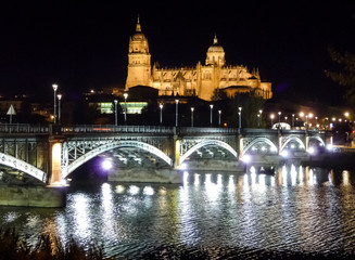Fototapeta premium Historic city of Salamanca with river Tormes at night, Spain