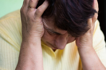 Fototapeta premium Older women with problems, holding his head